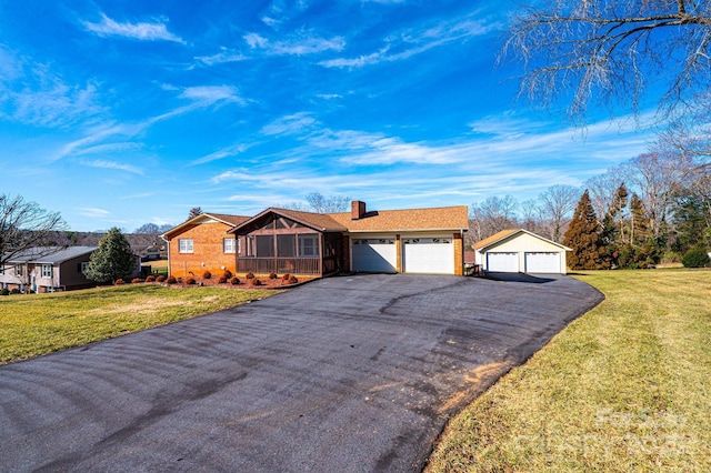 single story home with a garage and a front lawn