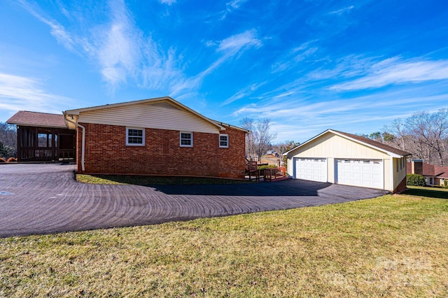 view of home's exterior featuring a garage and a lawn