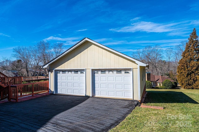 garage featuring a lawn