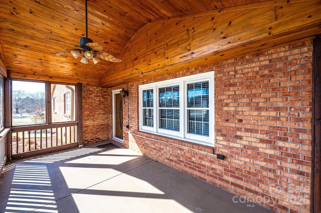 unfurnished sunroom with vaulted ceiling, wooden ceiling, and ceiling fan