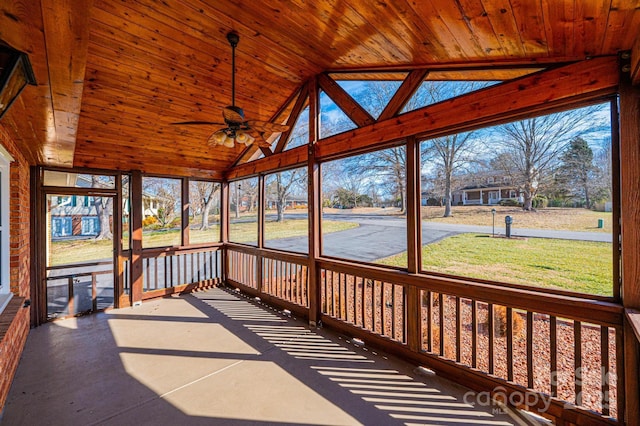 unfurnished sunroom with wood ceiling, vaulted ceiling, and ceiling fan