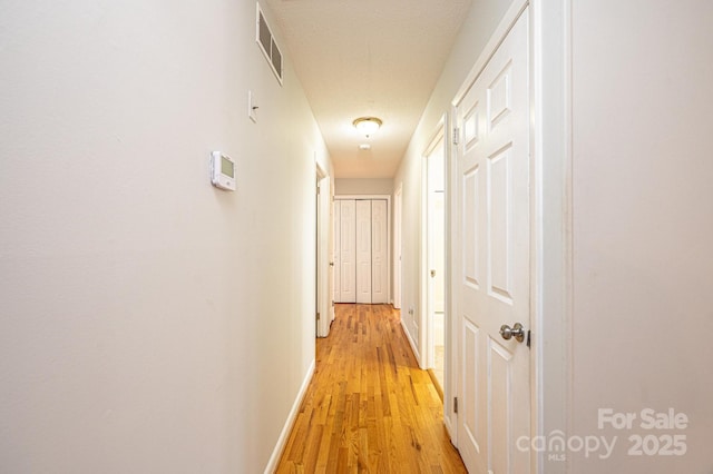 corridor featuring light hardwood / wood-style flooring