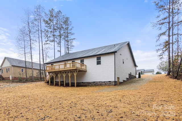 back of house featuring a deck