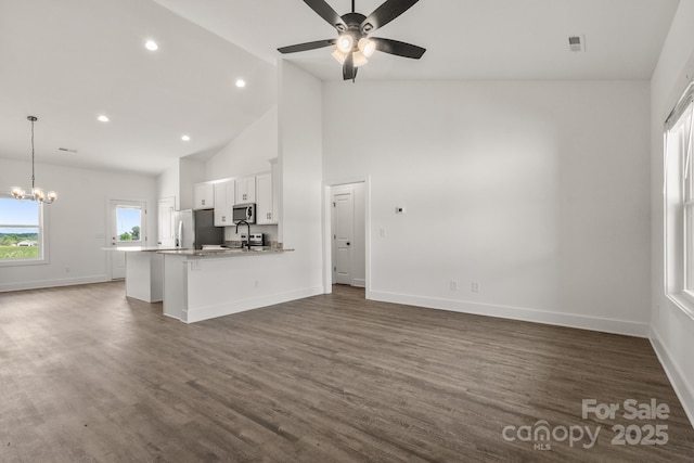 5177 Flay Rd, Lincolnton, NC 28021 - unfurnished living room with a chandelier, ceiling fan, baseboards, dark wood finished floors, and high vaulted ceiling