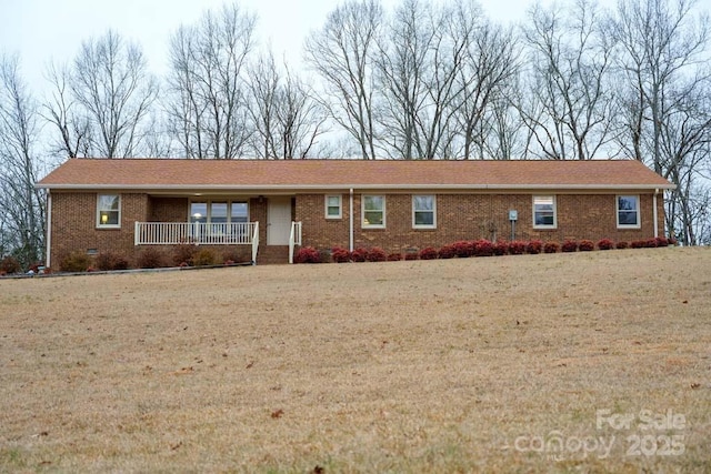 ranch-style house with a front lawn and covered porch