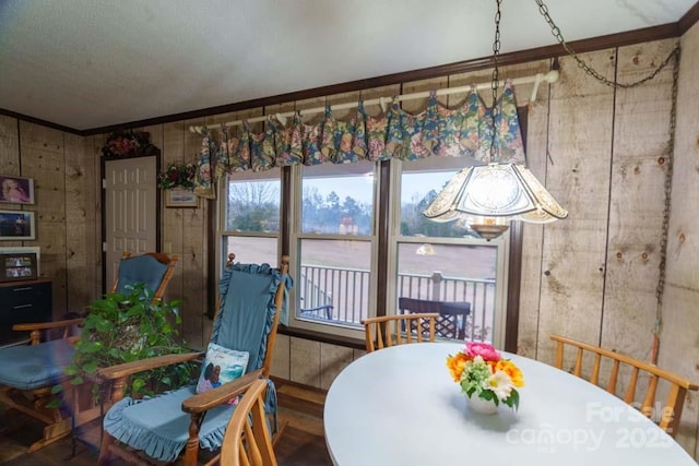 dining space with hardwood / wood-style flooring and ornamental molding