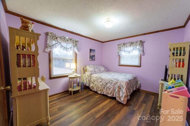 bedroom featuring crown molding, dark hardwood / wood-style flooring, and a textured ceiling