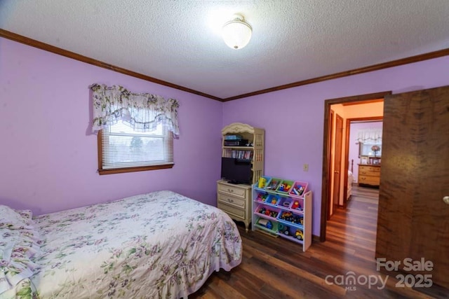 bedroom featuring ornamental molding, dark hardwood / wood-style floors, and a textured ceiling