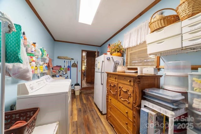 kitchen featuring white refrigerator, ornamental molding, dark hardwood / wood-style flooring, and separate washer and dryer