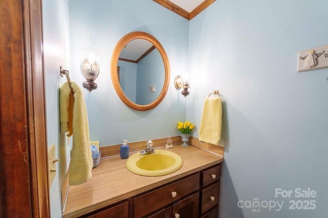 bathroom featuring crown molding and vanity