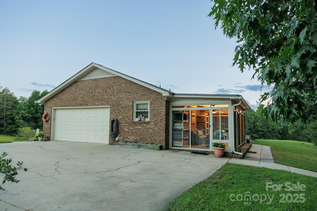 4816 Zion Church Rd, Concord, NC 28025 - view of front of property featuring an attached garage, brick siding, concrete driveway, a sunroom, and a front yard