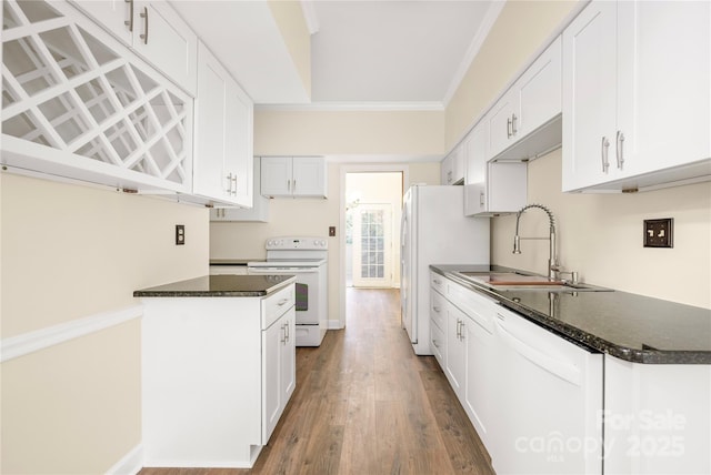 kitchen featuring sink, crown molding, white appliances, hardwood / wood-style floors, and white cabinets