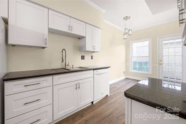 kitchen with pendant lighting, sink, crown molding, dishwasher, and white cabinetry