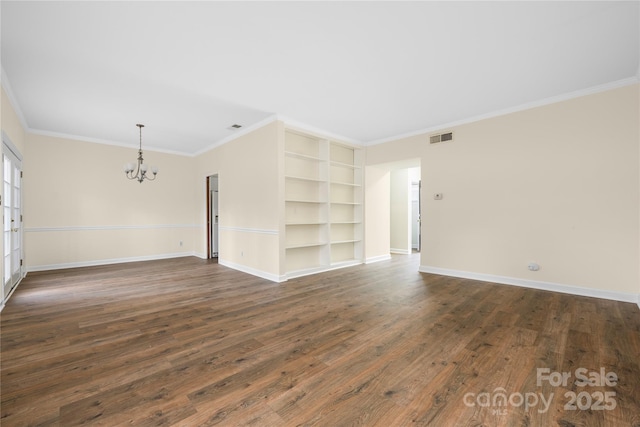 unfurnished room with dark wood-type flooring, crown molding, and an inviting chandelier