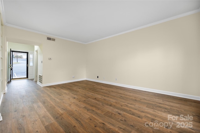 spare room with dark hardwood / wood-style flooring and ornamental molding