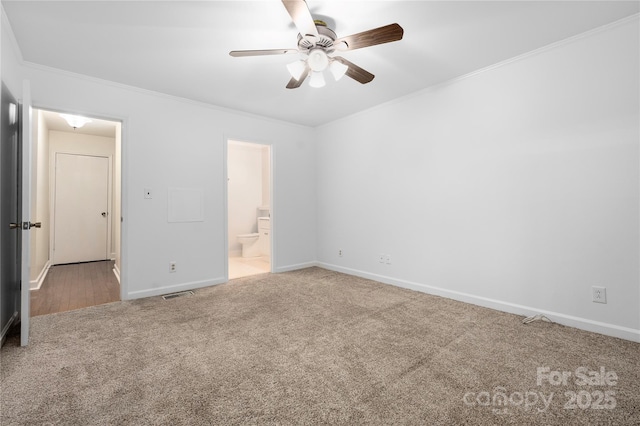 unfurnished bedroom featuring crown molding, carpet flooring, ensuite bathroom, and ceiling fan