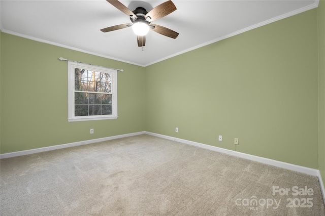 carpeted spare room with ornamental molding and ceiling fan