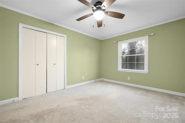 unfurnished bedroom featuring ornamental molding, a closet, and carpet flooring