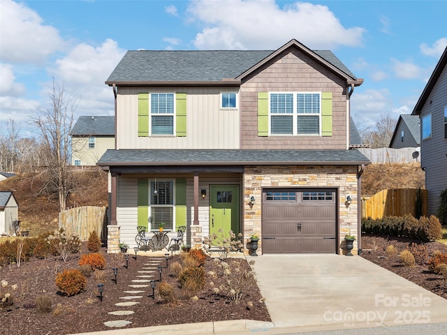 craftsman inspired home featuring a porch and a garage