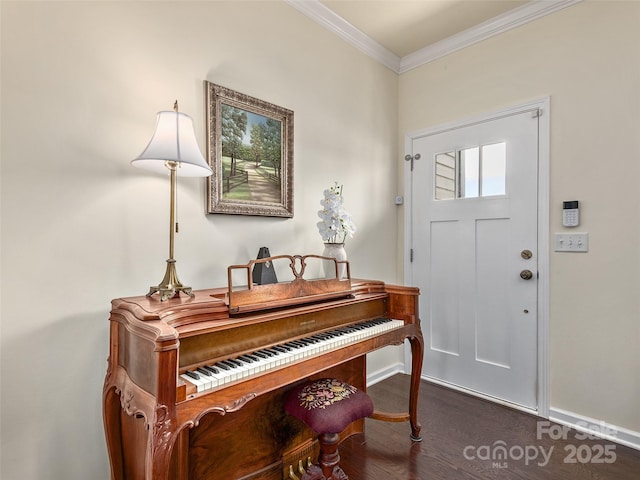 foyer with ornamental molding and dark hardwood / wood-style floors