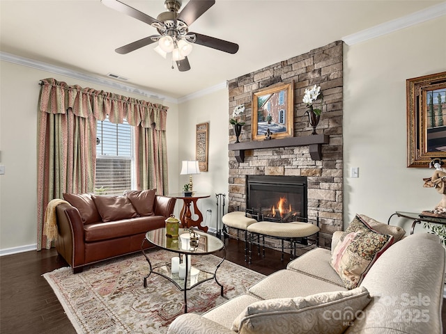 living room with ornamental molding, hardwood / wood-style floors, ceiling fan, and a fireplace