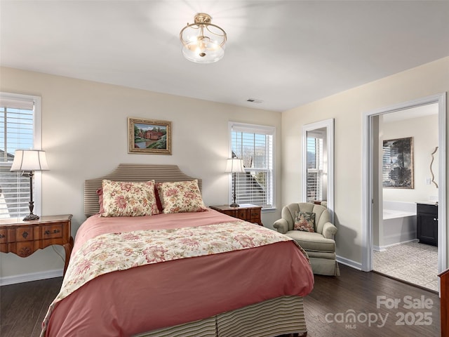 bedroom with dark hardwood / wood-style floors and connected bathroom