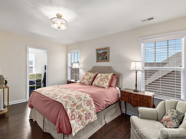 bedroom with dark hardwood / wood-style floors