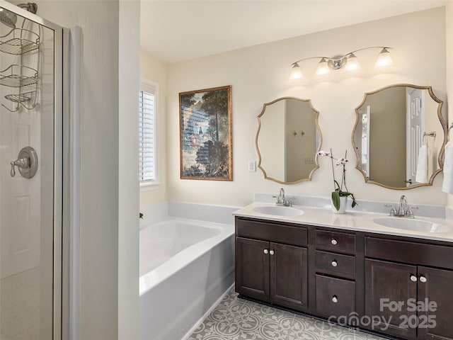 bathroom featuring plus walk in shower, vanity, and tile patterned floors