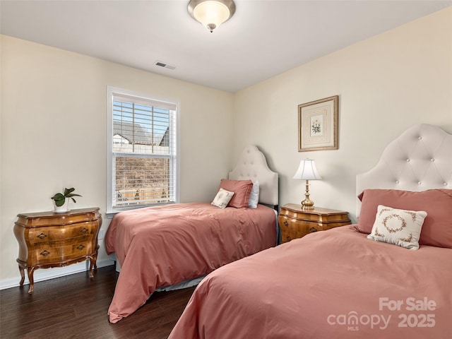 bedroom with dark wood-type flooring