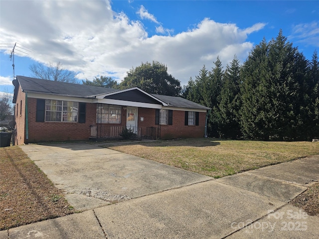 ranch-style house with a front yard and covered porch