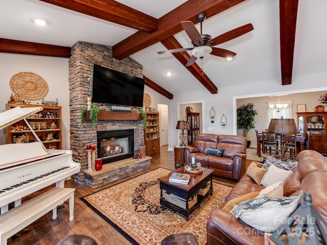 living room featuring hardwood / wood-style flooring, lofted ceiling with beams, ceiling fan with notable chandelier, and a fireplace