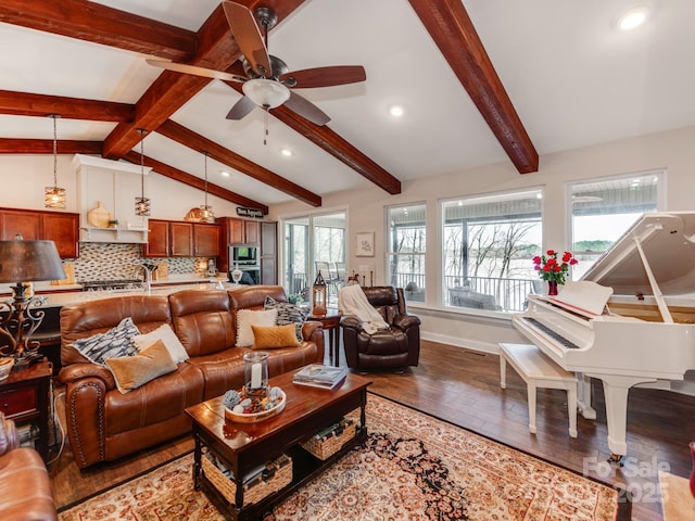 living room featuring hardwood / wood-style floors, ceiling fan, and vaulted ceiling with beams