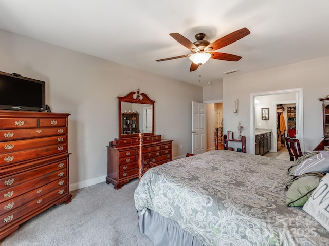 carpeted bedroom featuring ensuite bathroom and ceiling fan