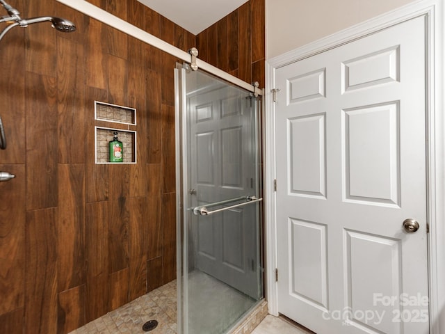 bathroom with walk in shower and wooden walls