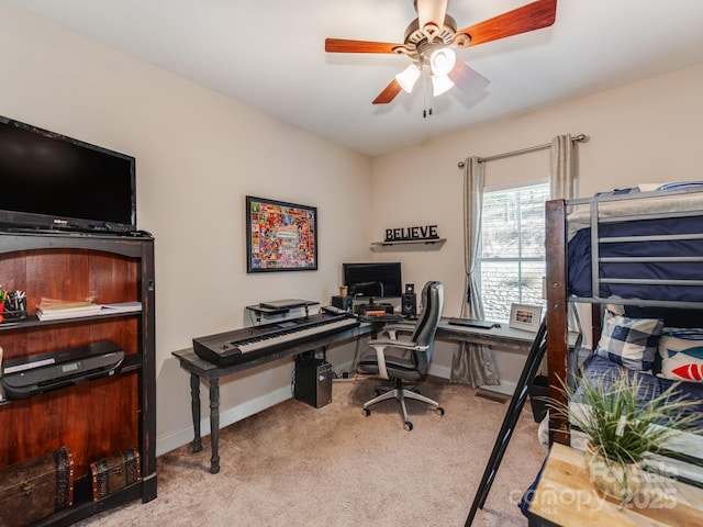 home office featuring light carpet and ceiling fan