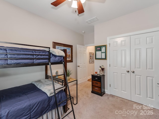 carpeted bedroom with a closet and ceiling fan