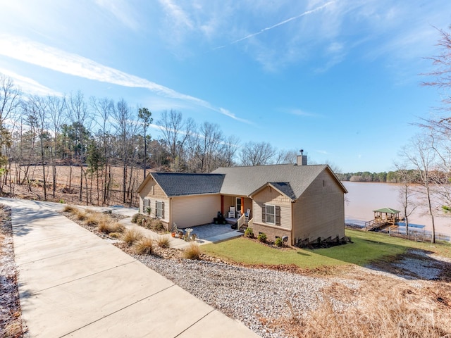 view of front facade with a water view and a front yard