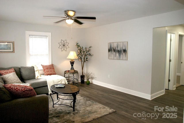 living room featuring ceiling fan and dark hardwood / wood-style flooring