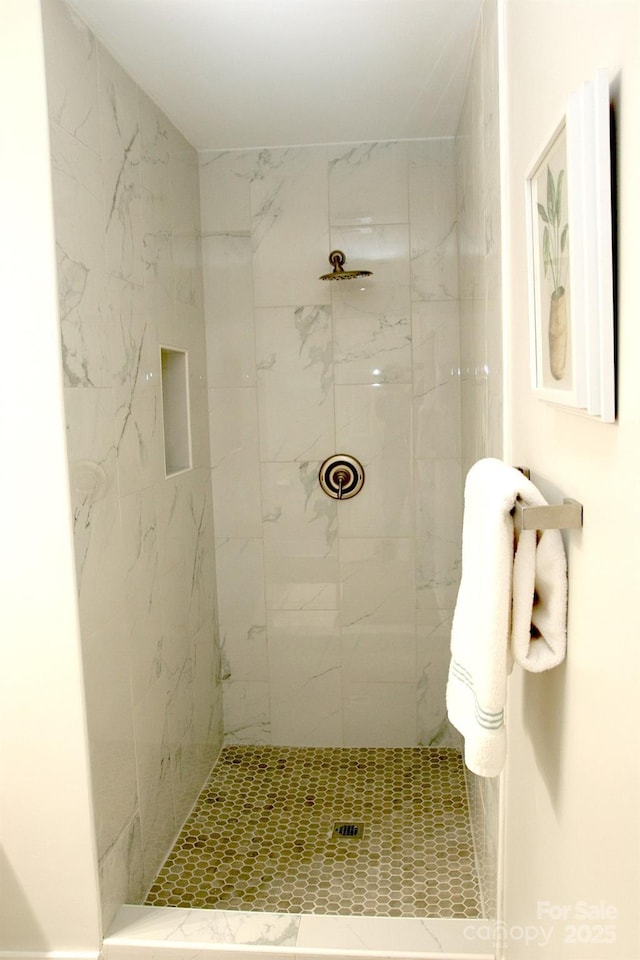 bathroom with a tile shower