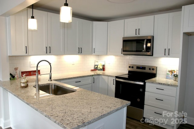 kitchen with sink, appliances with stainless steel finishes, light stone countertops, white cabinets, and decorative light fixtures