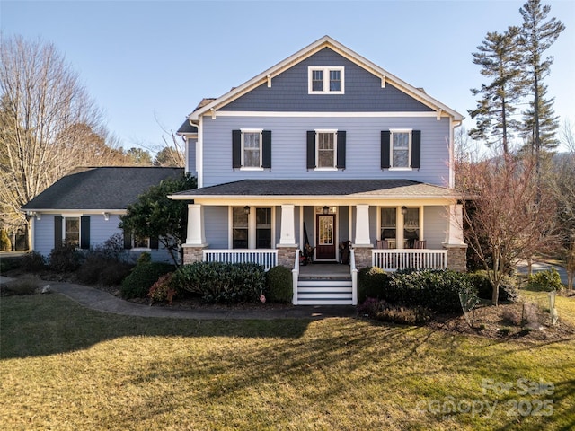 view of front of house with covered porch and a front lawn