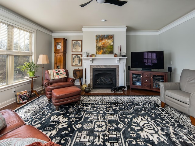 living room with ornamental molding, dark hardwood / wood-style floors, a fireplace, and ceiling fan