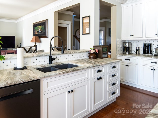 kitchen featuring white cabinetry, black dishwasher, sink, and light stone counters