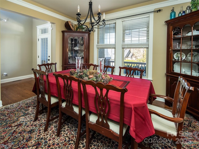 dining space with an inviting chandelier, dark hardwood / wood-style flooring, and crown molding