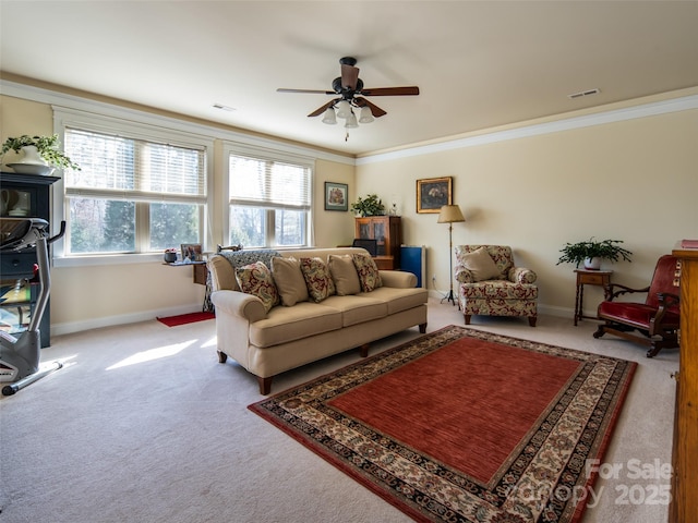 living room with ornamental molding, carpet, and ceiling fan