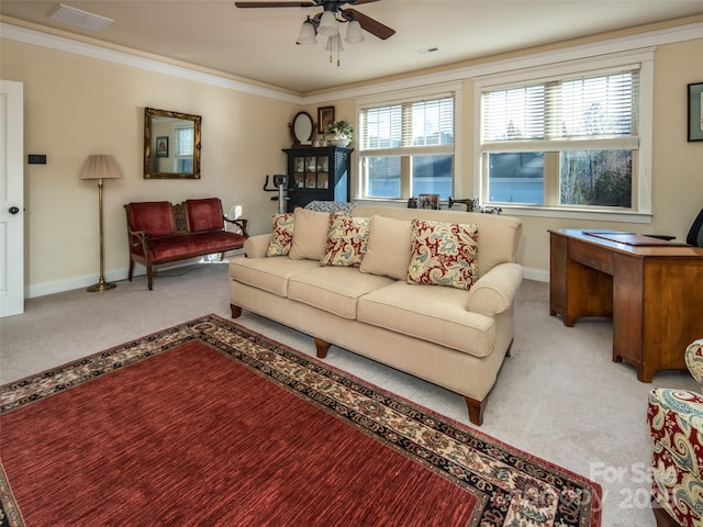 carpeted living room with crown molding and ceiling fan