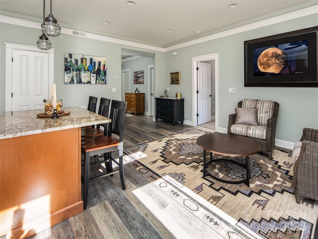 living room featuring dark wood-type flooring and ornamental molding