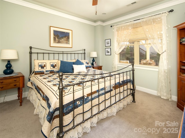 carpeted bedroom featuring ornamental molding and ceiling fan