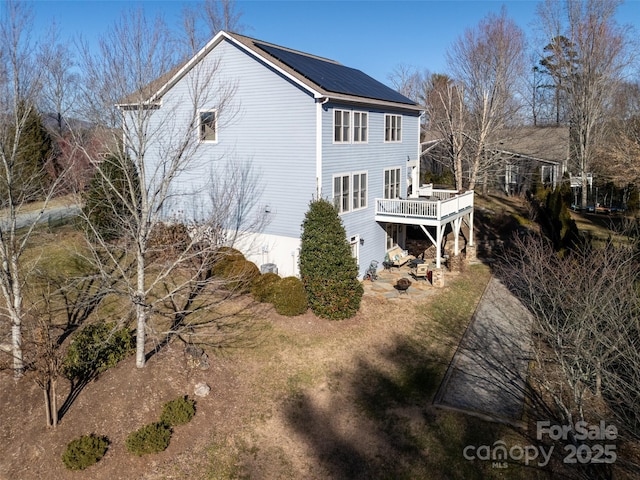 rear view of property with a wooden deck