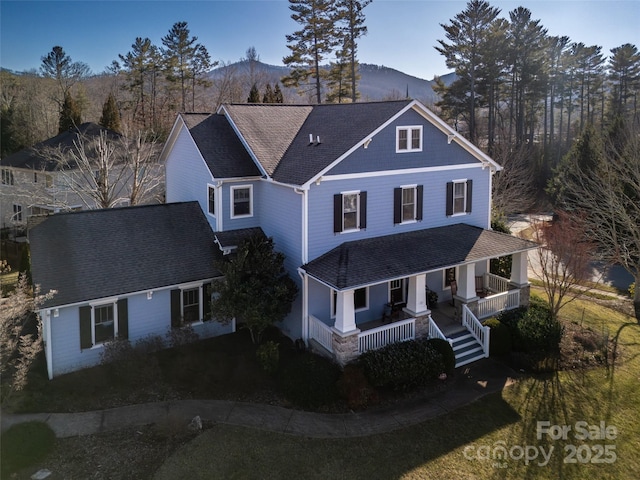 view of front property with a mountain view and covered porch